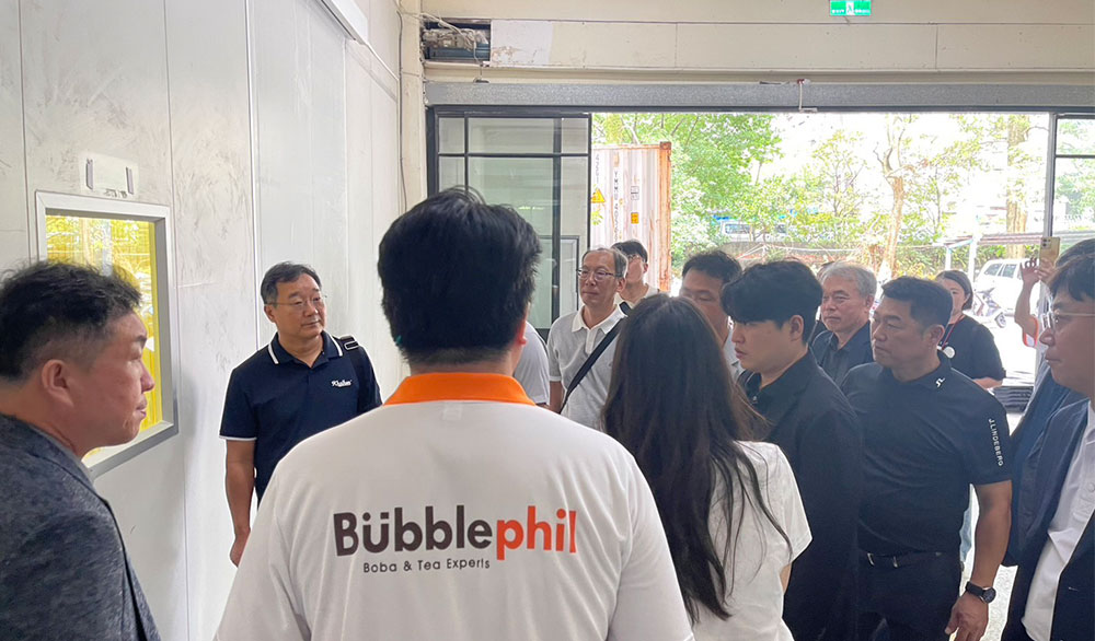A group of international business professionals and quality auditors conducting an on-site facility inspection at the T Foods tapioca pearl manufacturing plant.