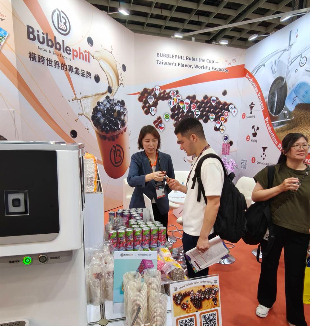 A bustling Taiwan Pavilion exhibition booth at an international food trade show, where the BubblePhil team is consulting with prospective global buyers and hospitality clients.