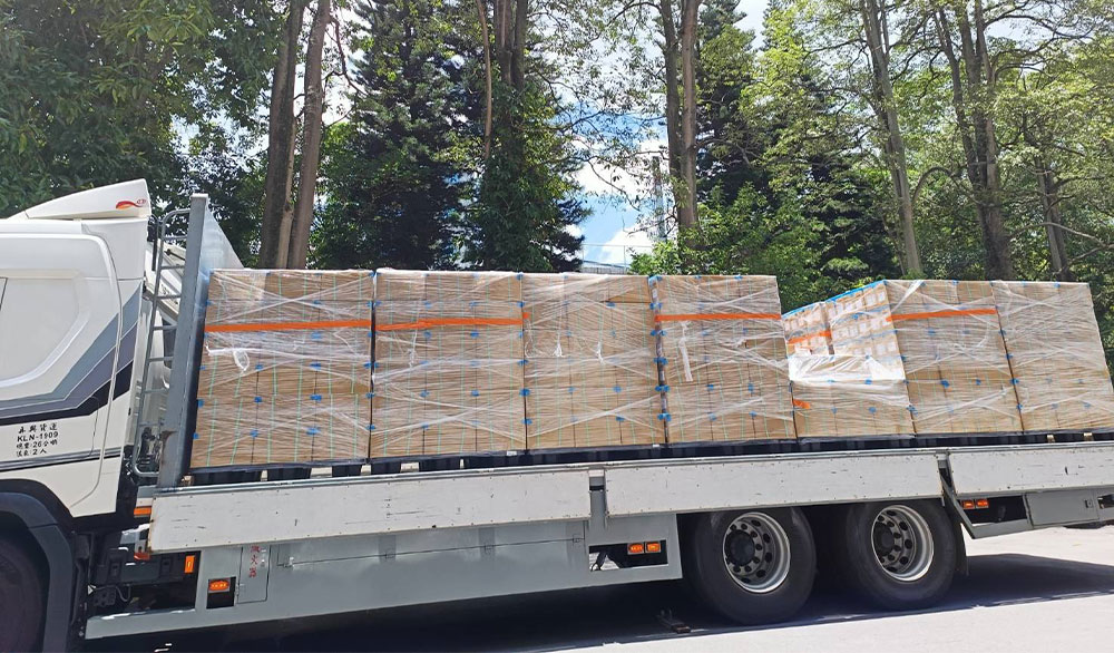A large logistics commercial truck loaded with rows of heavy-duty, shrink-wrapped cardboard boxes filled with tapioca pearls ready for global distribution.